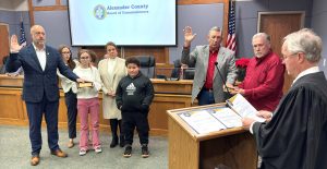 Judge Dale Graham administers the oath of office to Commissioners Josh Lail and Kent Herman.