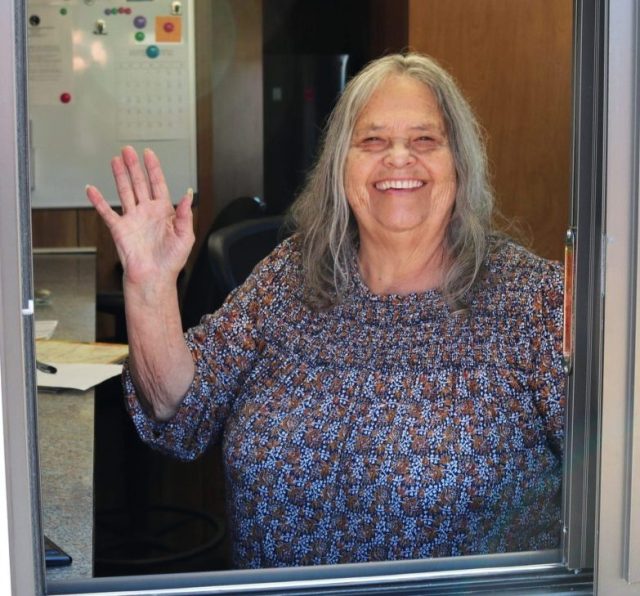 Sharon Watson waving from the window at the Solid Waste Facility.