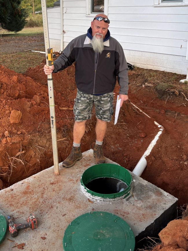 Bert Gibson, Environmental Health Supervisor, inspects a septic system.