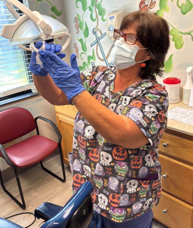 Kim James, Dental Assistant, is busy preparing the exam room for the next patient.