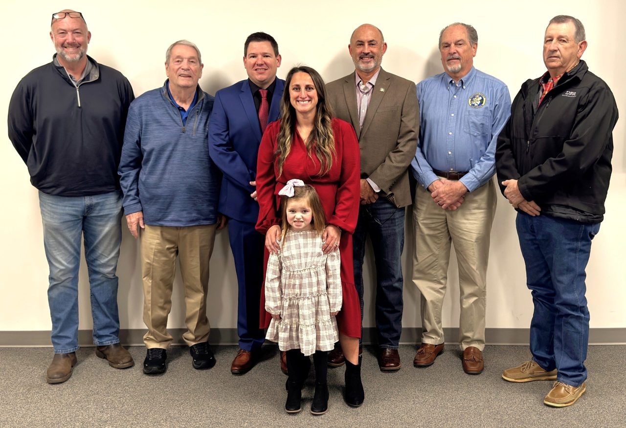 Justin Mundy and his family are pictured with the Alexander County Board of Commissioners.