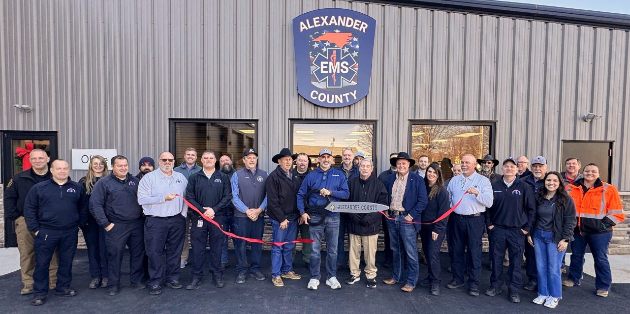 large group of people at a ribbon cutting for the new expansion at Alexander County EMS.