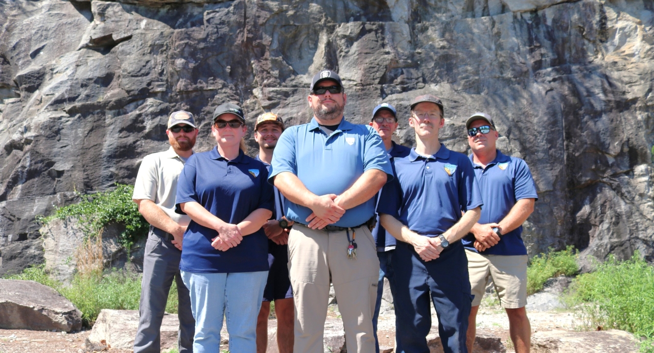Alexander County Parks Department staff are pictured in front of the cliff face at Rocky Face Park.