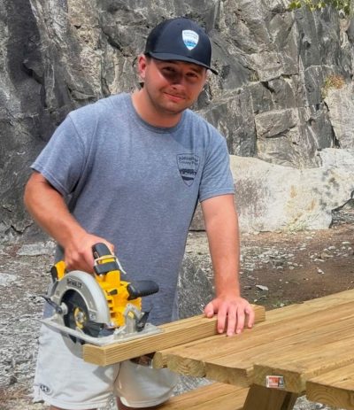 Luke Millsaps cutting boards for a new picnic table.